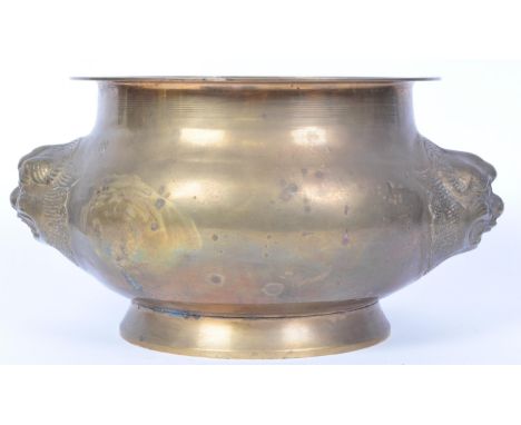 A vintage 20th Century heavy Chinese brass planter / vase. Having a flared circular top with protruding twin dragons. Measure