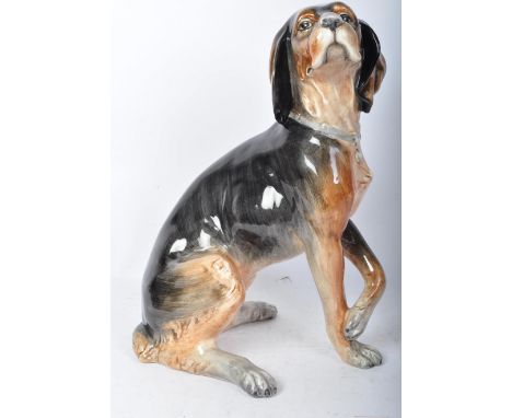 A large vintage retro mid 20th century porcelain beagle dog figure statue modelled in a sitting position with paws crossed. M
