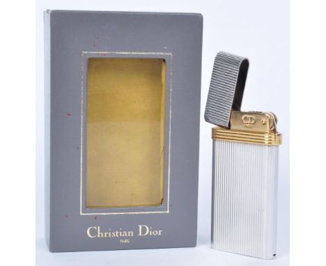 In the style of Christian DIor - A vintage boxed Christian Dior lighter in white and yellow metals complete in fitted case. T