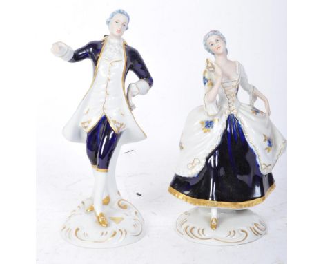 Two early 20th century Royal Dux Czech porcelain figurines in the form of a lady and gentleman in Regency attire, both standi