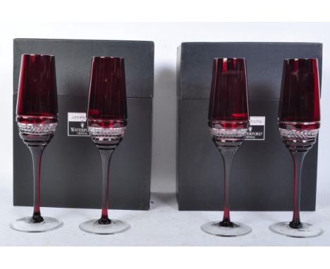 A set of four contemporary John Rocha for Waterford Crystal Red Voya ruby crystal flute glasses having hobnail decoration rai