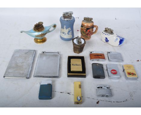 A collection of vintage 20th century cigarette lighters to include a Wedgwood Jasperware style lighter, zippo lighters, Dutch