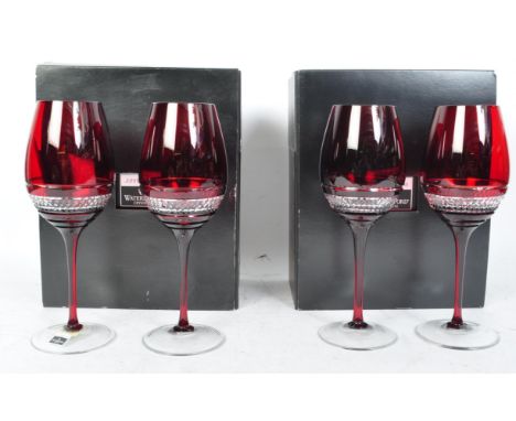 A set of four contemporary John Rocha for Waterford Crystal Red Voya ruby crystal wine glasses having hobnail decoration rais