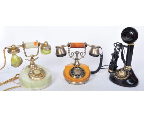 An assortment of three mid 20th century telephone to include a candlestick telephone with brass fittings and two pother vinta