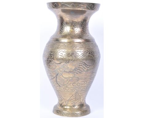 A vintage 20th Century Chinese brass vase. Having a circular flared top with bulbous body, incised with&nbsp; dragon and shru