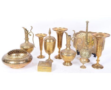 A collection of vintage 20th century Persian Islamic brassware. The lot to include various sizes candlesticks, a pair of ewer