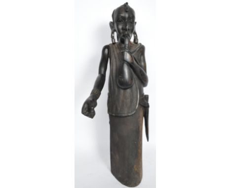 A large vintage 20th century African tribal carved ebony floor standing sculpture. To depict a figure playing a musical instr