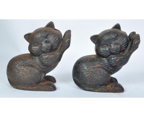 A pair of vintage mid 20th century cast metal kitsch book ends in the form of cats clawing the book edge. Measures 15cm tall.