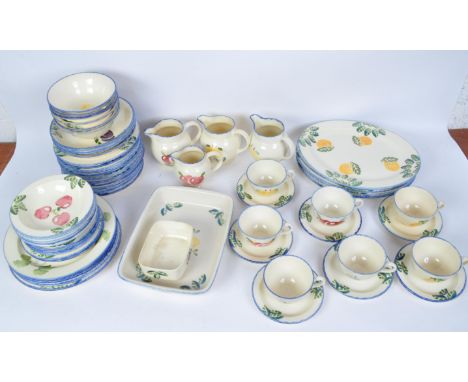 A large vintage 20th century Poole Pottery hand painted dinner and tea service comprising of teacups, saucers, baking dishes,