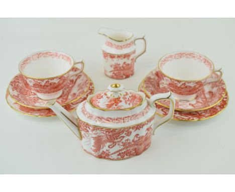 Royal Crown Derby in the Red Aves pattern to include a small teapot, two trios and a cream jug (8).  In good condition with n