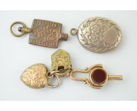 A 9ct gold folding watch key, set bloodstone and agate, with a yellow metal heart pendant stamped 10k, and pinchbeck padlock,