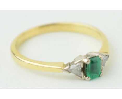 18ct yellow gold Art Deco style ring set with central baguette cut emerald and two diamonds. Ring size 'R' Weight 3.2 grams.