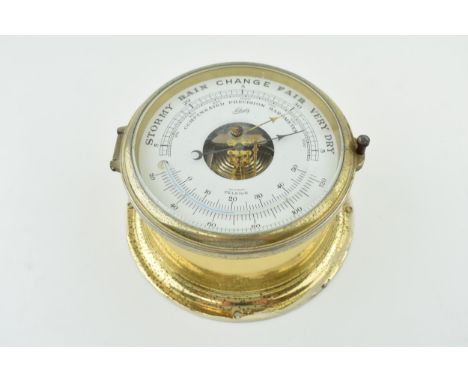 A Schatz bulkhead marine thermometer and barometer with brass outer case. Made in Germany. Bevelled glass. Dial diameter 14cm