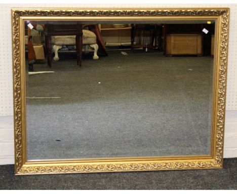 A large 20th century gilt composite framed wall mirror with bevelled rectangular plate, 88 x 113cm