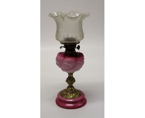 An Edwardian paraffin table lamp, with frilled etched shade, pink satin reservoir, brass column and stepped ceramic base, 54c