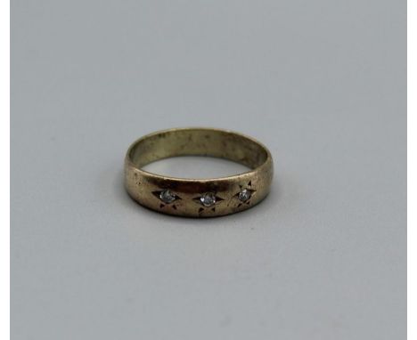 A 9ct gold band ring set with three Gypsy set diamond, size R,&nbsp;weight approximately 3.1gm