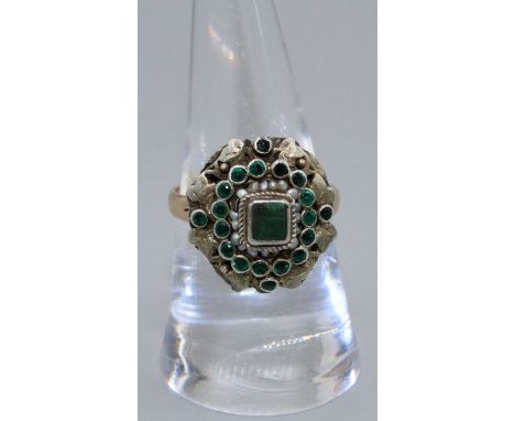 An antique Emerald set cluster ring. Circa 19th century in the style of Austro-Hungarian jewellery. Featuring a gilded head, 