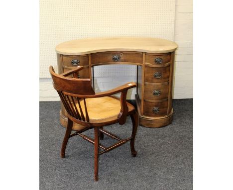 A 20th century kidney shape twin pedestal desk, together with an Edwardian beech stick back office armchair with close studde