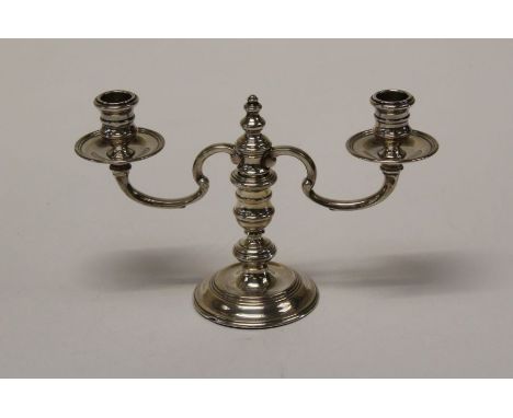 Richard Comyns, an Elizabeth II silver table candlestick with detachable two arm sconces on knopped column and circular sprea