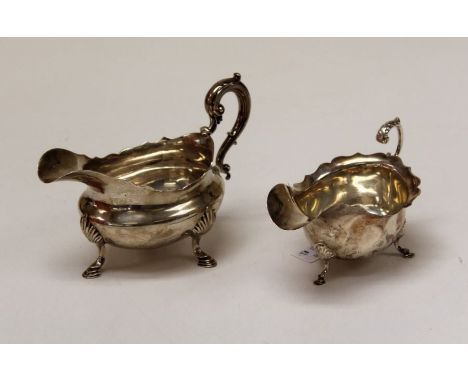 Two sterling silver sauce boats. The first a William IV footed sauce boot with scallop and hoof feet, scallop rimed, with scr