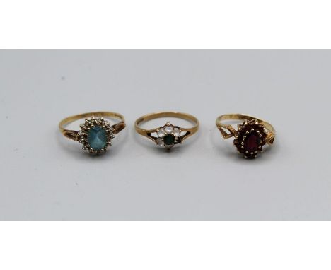 Three 9ct gold stone set rings, one a garnet cluster, size M 11/2, a topaz and diamond cluster, size S and a cubic zirconia/ 