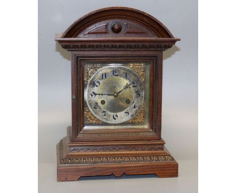 A late 19th century mantle clock, the architectural oak case containing an eight day movement striking upon two gongs, faced 