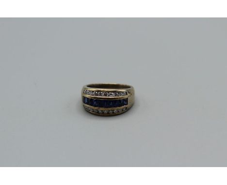 A diamond and sapphire dress ring. In yellow metal with 18k stamp to shank. Metalwork is tarnished and damaged, size N,&nbsp;