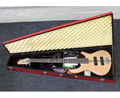 A Cort electric bass five string guitar, model A5, circa 2006. Serial number 04112391, in a red painted wood case with a Korg