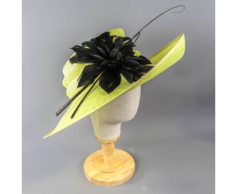 PETER BETTLEY LONDON - Lime green occasion hat, with black feather flower and twirl and stick detail, internal circumference 