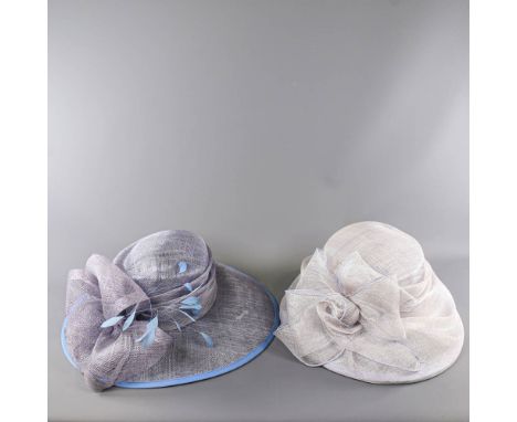 A HAT DESIGN STUDIO - 2 blue occasion hats, one powder blue with feather and bow detail, the other light ice blue with mesh r