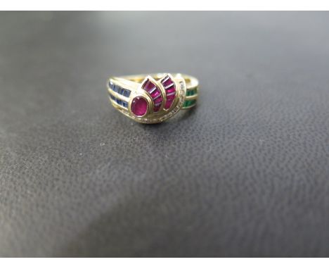 An emerald, ruby, sapphire and diamond dress ring - Stamped 18K - Ring size N 1/2 - Weight approx 5.8gms
Condition Report: Go