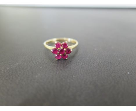 A ruby daisy cluster ring - Stamped 585 - Ring size N 1/2 - Weight approx 2.3gms
Condition Report: Good