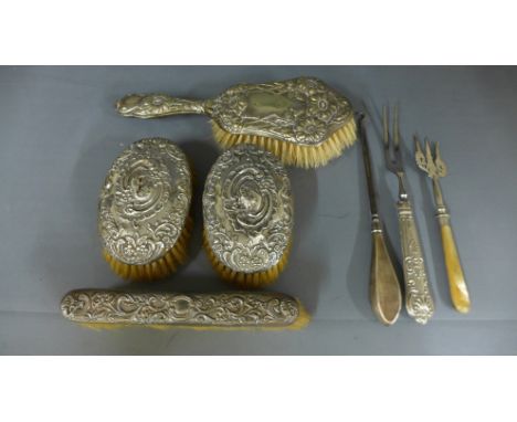 A silver backed hairbrush, two clothes brushes, a crumb brush, button hook, mother of pearl handled toasting fork and silver 