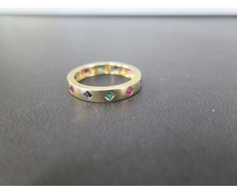 An emerald, sapphire and ruby full-circle band ring - Stamped 9K - Ring size T - Weight approx 3.5gms
Condition Report: Good 