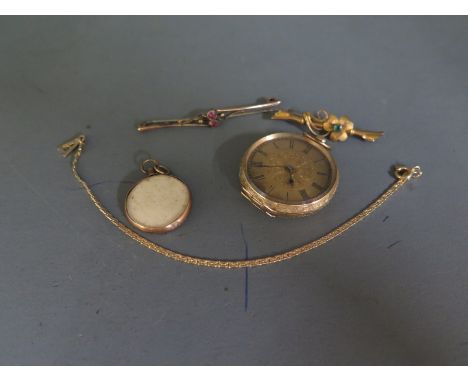 An early 20th century Continental 14K gold fob watch with engine turned dial having Roman Numerals and elaborate foliate deco