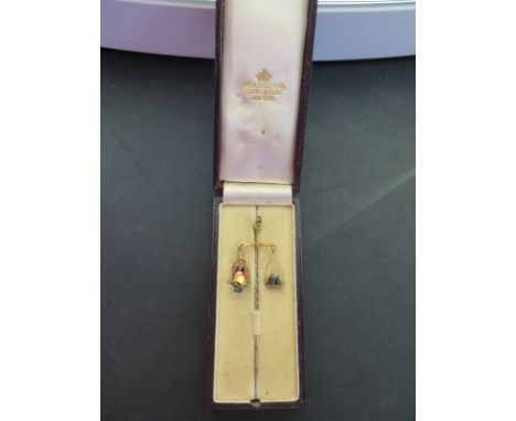 A hinged jockey stickpin - Designed as an enamel jockey with saddle weighing in - In a C & A GIULIANO fitted case - Appears t