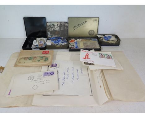 A quantity of stamps in various tins and a collection of First Day covers and envelopes