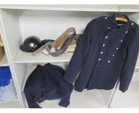 A Fireman's tunic, overcoat, leather belt, axe, tin helmet and literature relating to The Huntingdon and Peterborough Fire Se