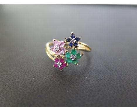 A 9ct gold multi-gem floral dress ring - To include diamond, ruby, sapphire and emerald - Hallmarked Birmingham - Ring size T