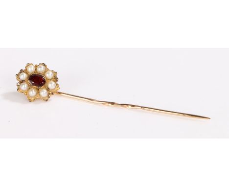 Gold coloured metal stick pin, the head set with a central garnet surrounded by pearls, 3.6g