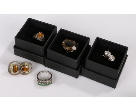 Cubic zirconia set crossover style ring, tigers eye ring and pair of earrings, citrine style ring, green and clear paste set 