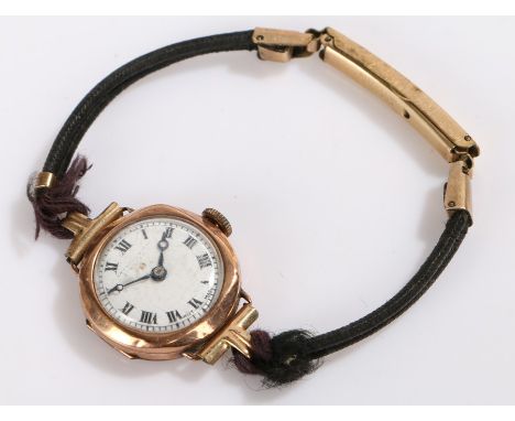 Ladies 9 carat gold wristwatch, the white dial with Roman numerals and faint retailers name, manual wound
