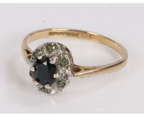 9 carat gold ring, set with a central sapphire surrounded by clear paste, ring size K, 1.5g