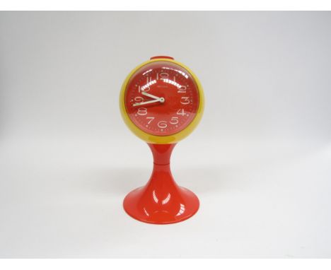 A Marksman West German alarm clock of globe form on tulip base in yellow and orange plastic 21.5 high 