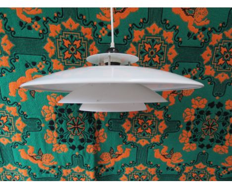 A Danish Poulsen style ceiling light of four tiers in white. Approx 43cm diameter 