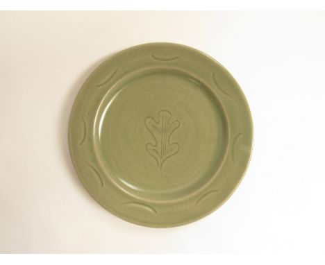 A St Ives Leach Pottery a rare oak leaf early studio pottery plate with impressed pottery seal. 24.5cm diameter 