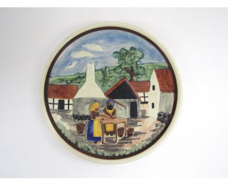 A Bornholm of Sweden ceramic dish with relief moulded village scene with figures, hand-painted.  23.5cm diameter 