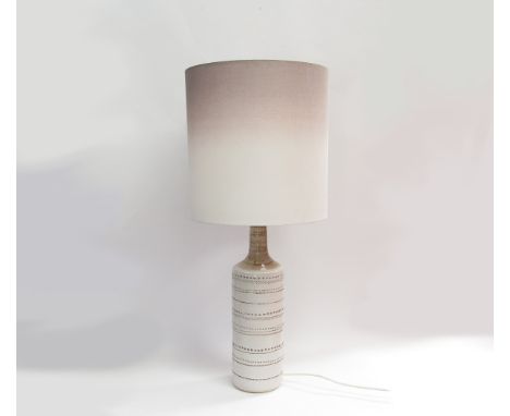 A Bitossi lamp base in white with impressed motifs (possibly made for Pier UK) with shade. Base  54cm high, overall 94cm 