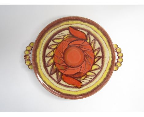 A Dumler &amp; Breiden ceramic cake platter in orange glazes. 30.5cm diameter, 36cm with handles 