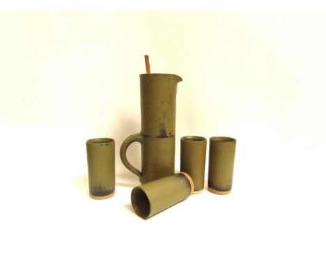 ROBIN WELCH (1936-2019) A studio pottery domestic range tall cylindrical jug and four matching tumblers all with an olive gre